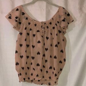 Pink blouse with black hearts on it